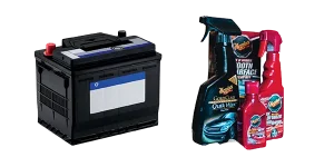 A car battery and several spray bottles of car cleaners and polishes